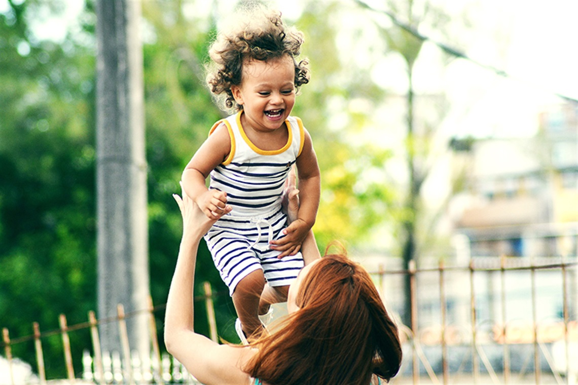 Mother holding a baby aloft