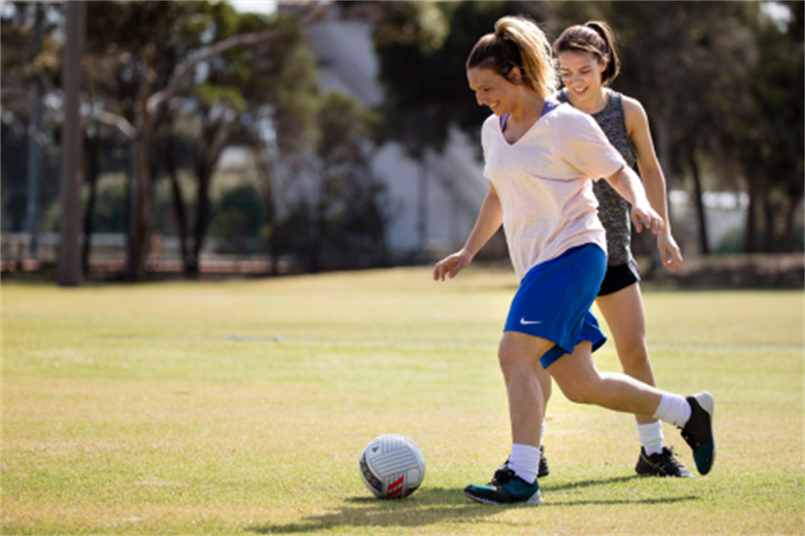 Woman_running_to_kick_a_soccer_ball.png