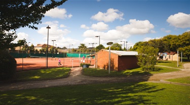 Tennis courts and clubhouse in Ardrie Park