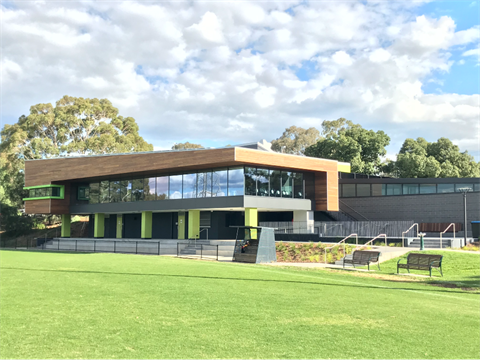 Dunlop pavillion building next to oval with seating