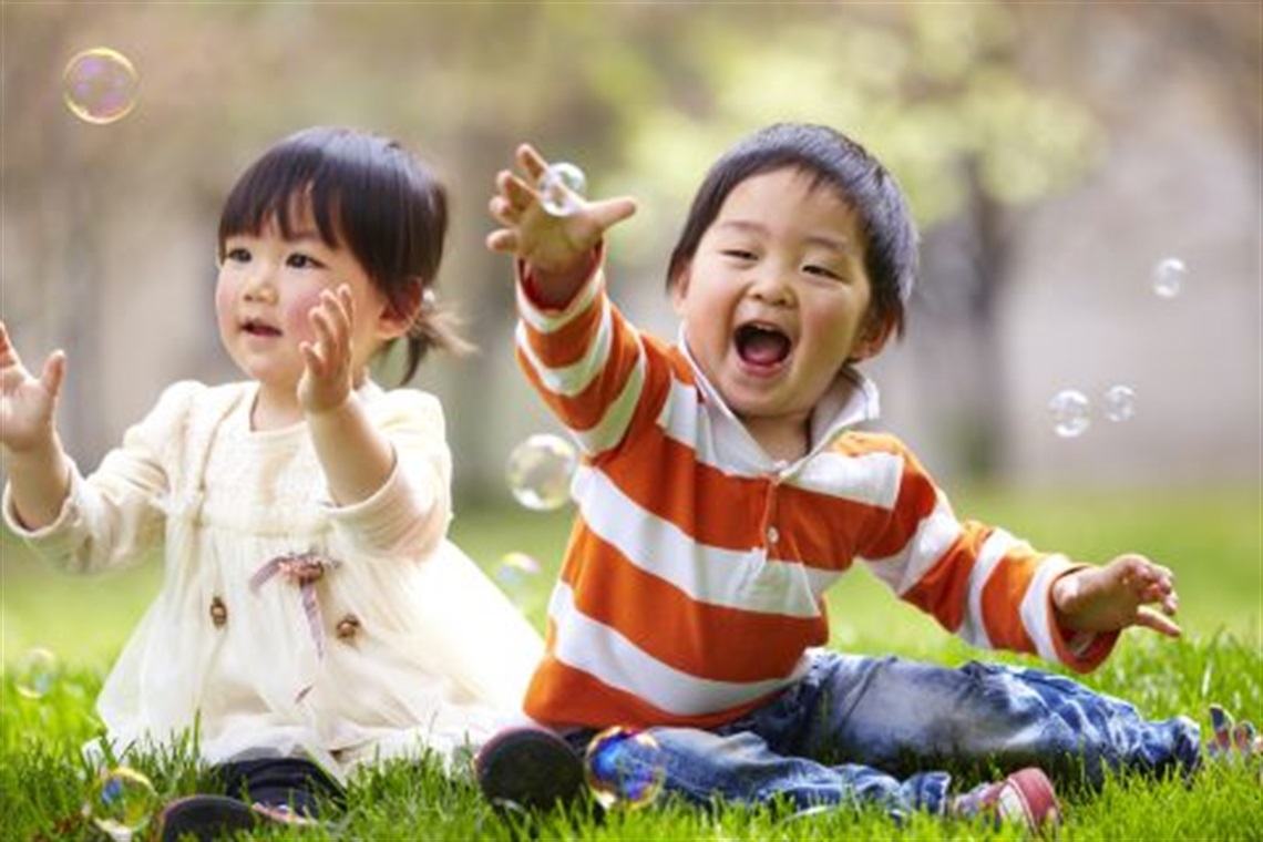 two_young_toddlers_playing_outside_with_bubbles.jpg