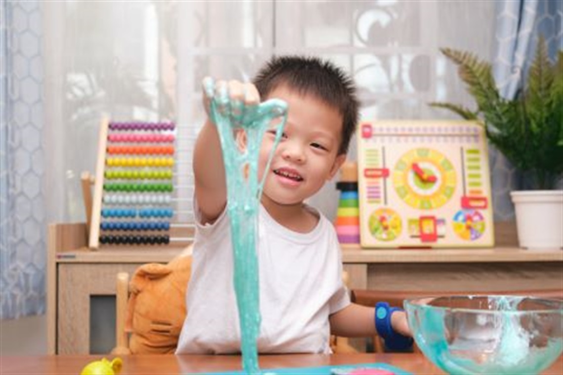 Young_child_stretching_blue_slime