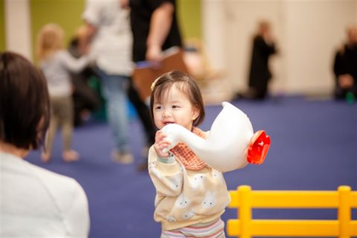 Toddler_holding_a_duck_toy