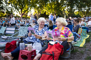 Classics audience holding event programs