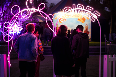 A group of people in front of an illuminated