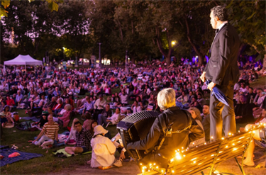 Performer singing on stage at Victoria Gardens