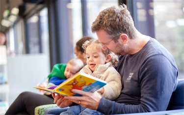 Man reading book to young child