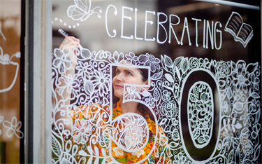 Woman drawing on window