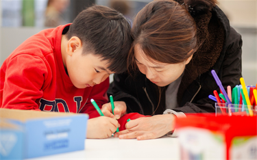 Women and boy drawing